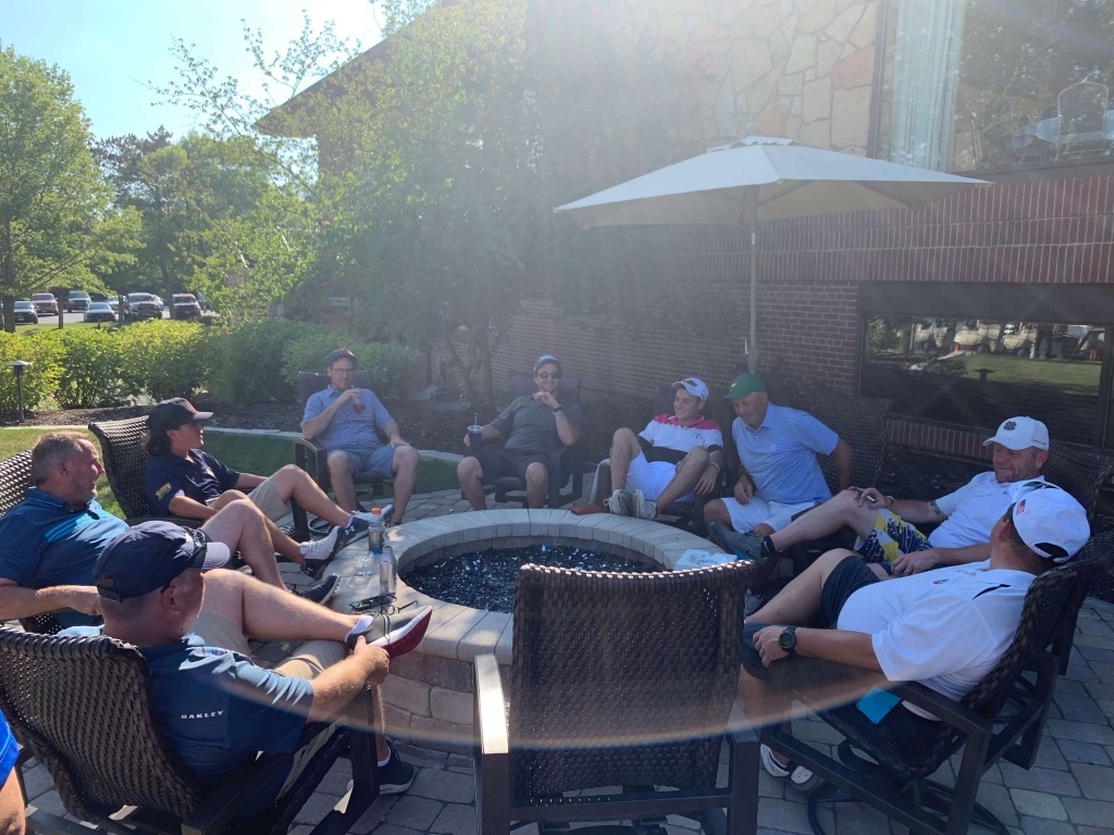 men gathering around a bonfire