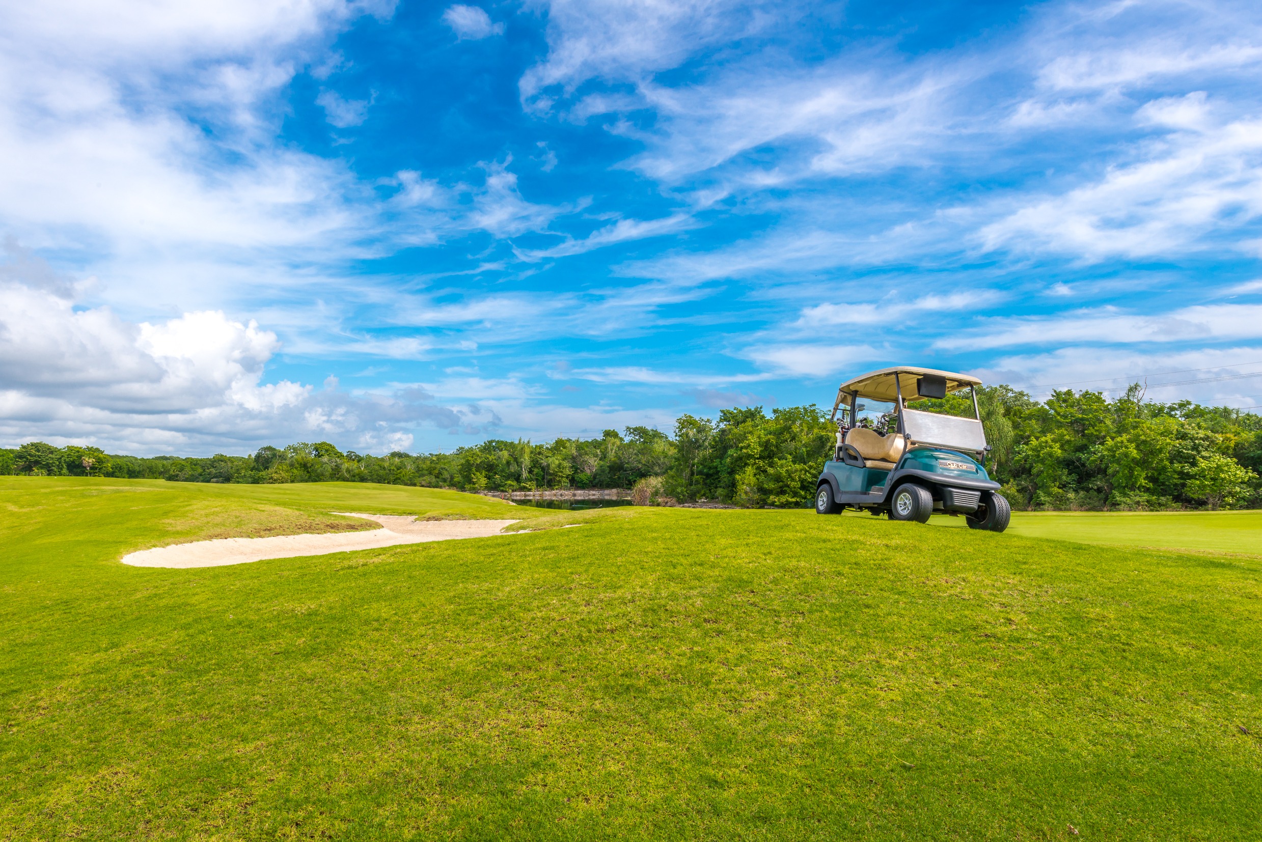 Sand bunkers and a golf cart at the golf course